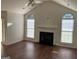 Inviting living room featuring a fireplace, vaulted ceiling, and large windows for ample natural light at 40 Canterbury Dr, Grantville, GA 30220