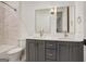 Bathroom features double sink vanity with gray cabinets and two mirrors at 434 Selborne Way, Chattahoochee Hills, GA 30268