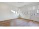 Bright bedroom featuring hardwood floors, large windows, and a door leading to a balcony at 434 Selborne Way, Chattahoochee Hills, GA 30268