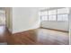 Bright bedroom features hardwood floors, large windows with roller shades, and neutral paint at 434 Selborne Way, Chattahoochee Hills, GA 30268