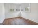 Bedroom featuring hardwood floors and three windows at 434 Selborne Way, Chattahoochee Hills, GA 30268