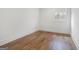 Bedroom features hardwood floors, white walls, and single window at 434 Selborne Way, Chattahoochee Hills, GA 30268