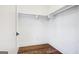 Walk-in closet featuring hardwood floors, white shelving, and ample storage space at 434 Selborne Way, Chattahoochee Hills, GA 30268