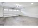 Spacious garage with cement floor and a white garage door with windows to allow natural light at 434 Selborne Way, Chattahoochee Hills, GA 30268