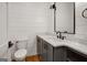 Charming half bathroom with shiplap walls, gray vanity, marble countertop, and modern fixtures at 434 Selborne Way, Chattahoochee Hills, GA 30268