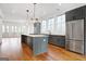 Stylish kitchen featuring an island, stainless appliances, and plenty of natural light at 434 Selborne Way, Chattahoochee Hills, GA 30268