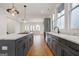 Beautiful kitchen with a large island, modern fixtures, and sleek stainless steel appliances at 434 Selborne Way, Chattahoochee Hills, GA 30268