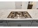 Close-up of a kitchen island featuring a cooktop and a marble countertop at 434 Selborne Way, Chattahoochee Hills, GA 30268