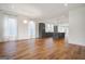 Spacious living area with hardwood floors and an open floorplan with views into the modern kitchen at 434 Selborne Way, Chattahoochee Hills, GA 30268