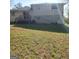 View of the back of the house, deck, basement entry, and spacious yard at 6521 King William Dr, Morrow, GA 30260