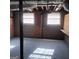 Unfinished basement with concrete floor, exposed ceiling, and window at 6521 King William Dr, Morrow, GA 30260