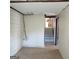 Unfinished basement with tile floor, open ceiling and stairs to upper level at 6521 King William Dr, Morrow, GA 30260