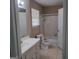Bathroom features a shower/bath, toilet, vanity and a bright window at 6521 King William Dr, Morrow, GA 30260