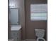 Bathroom features a toilet, vanity with a mirror and bright window at 6521 King William Dr, Morrow, GA 30260