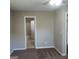 View from a bedroom of the attached bathroom with tile flooring and white toilet at 6521 King William Dr, Morrow, GA 30260