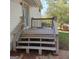 Wooden deck with stairs leading to backyard and sliding glass door access to the house at 6521 King William Dr, Morrow, GA 30260