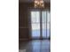 Dining room featuring a sliding glass door with vertical blinds overlooking the back yard at 6521 King William Dr, Morrow, GA 30260