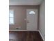 Sunlit living room with hardwood floors, neutrally painted walls, and an entryway at 6521 King William Dr, Morrow, GA 30260