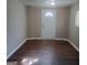 Neutrally painted room featuring hard wood floors and a bright white door at 6521 King William Dr, Morrow, GA 30260