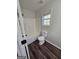 Bathroom featuring a shower-tub combo with white tile, a toilet, and a window with natural light at 1857 Oak Hill Springs Blvd, Lithonia, GA 30058