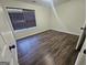 Bedroom featuring wood-look flooring, a window, base molding, and neutral paint at 1857 Oak Hill Springs Blvd, Lithonia, GA 30058