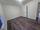 Bright, empty bedroom featuring wood-look flooring, base molding, and neutral paint at 1857 Oak Hill Springs Blvd, Lithonia, GA 30058