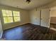 Bedroom featuring wood flooring, a window, neutral paint, and closet at 1857 Oak Hill Springs Blvd, Lithonia, GA 30058