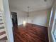 Open dining room with hardwood floors, traditional chandelier, and a staircase in view at 1857 Oak Hill Springs Blvd, Lithonia, GA 30058