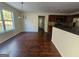Open-concept dining area leading to the kitchen, featuring hardwood floors and ample natural light at 1857 Oak Hill Springs Blvd, Lithonia, GA 30058