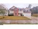 Charming two-story home featuring a symmetrical facade, brick accents, and a well-maintained front lawn at 1857 Oak Hill Springs Blvd, Lithonia, GA 30058
