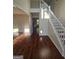 Spacious foyer featuring gleaming hardwood floors, a staircase with white railings, and natural light at 1857 Oak Hill Springs Blvd, Lithonia, GA 30058