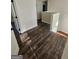 Upstairs hallway with wood flooring leading to rooms with neutral wall paint at 1857 Oak Hill Springs Blvd, Lithonia, GA 30058