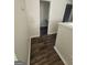 Neutral hallway featuring wood-look flooring and a partial view of a room at the end of the hall at 1857 Oak Hill Springs Blvd, Lithonia, GA 30058