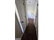 Hallway leading to laundry area, showcasing hardwood flooring and white doors at 1857 Oak Hill Springs Blvd, Lithonia, GA 30058