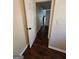 Hallway with hardwood floors and doors leading to various rooms of the home at 1857 Oak Hill Springs Blvd, Lithonia, GA 30058
