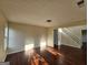 Bright living room with hardwood flooring, neutral walls, and staircase access at 1857 Oak Hill Springs Blvd, Lithonia, GA 30058