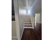 Bright foyer with hardwood staircase featuring white risers and classic white railing at 1857 Oak Hill Springs Blvd, Lithonia, GA 30058