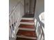Close up of hardwood stairs with white trim and handrail leading to the second floor at 1857 Oak Hill Springs Blvd, Lithonia, GA 30058