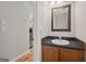 Half bathroom boasts a stylish mirror, wood cabinets, and hardwood floors at 60 Charlotte Blvd, Stockbridge, GA 30281