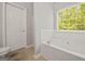 Bathroom features a bathtub with tile surround and a toilet at 60 Charlotte Blvd, Stockbridge, GA 30281
