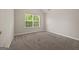 Bedroom featuring neutral walls and carpet, a bright window and natural light at 60 Charlotte Blvd, Stockbridge, GA 30281