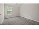 Cozy bedroom features plush carpet and a window providing natural light at 60 Charlotte Blvd, Stockbridge, GA 30281