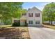 Inviting two-story home with red shutters, a well-manicured lawn, and mature trees at 60 Charlotte Blvd, Stockbridge, GA 30281