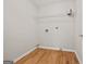Bright laundry room with a hardwood floor, shelving, and utility connections at 60 Charlotte Blvd, Stockbridge, GA 30281