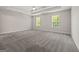 Spacious main bedroom features plush carpet, natural light, and a tray ceiling with fan at 60 Charlotte Blvd, Stockbridge, GA 30281