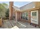 A brick home with an outdoor wooden deck, windows, and a door for access to the backyard at 249 Edenwylde Ct, Hampton, GA 30228