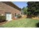Spacious backyard featuring green grass, an AC unit, and a wooden fence creating a private outdoor space at 249 Edenwylde Ct, Hampton, GA 30228