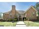 Brick home featuring a well-maintained backyard with lush green lawn and a spacious wooden deck at 249 Edenwylde Ct, Hampton, GA 30228