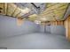 Basement featuring exposed ceilings, brick wall, and gray painted floor at 249 Edenwylde Ct, Hampton, GA 30228