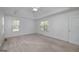 Comfortable bedroom features neutral carpet, a tray ceiling, and bright windows at 249 Edenwylde Ct, Hampton, GA 30228